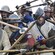Men, dressed as Scottish warriors from the era of William Wallace, snarl with their spears